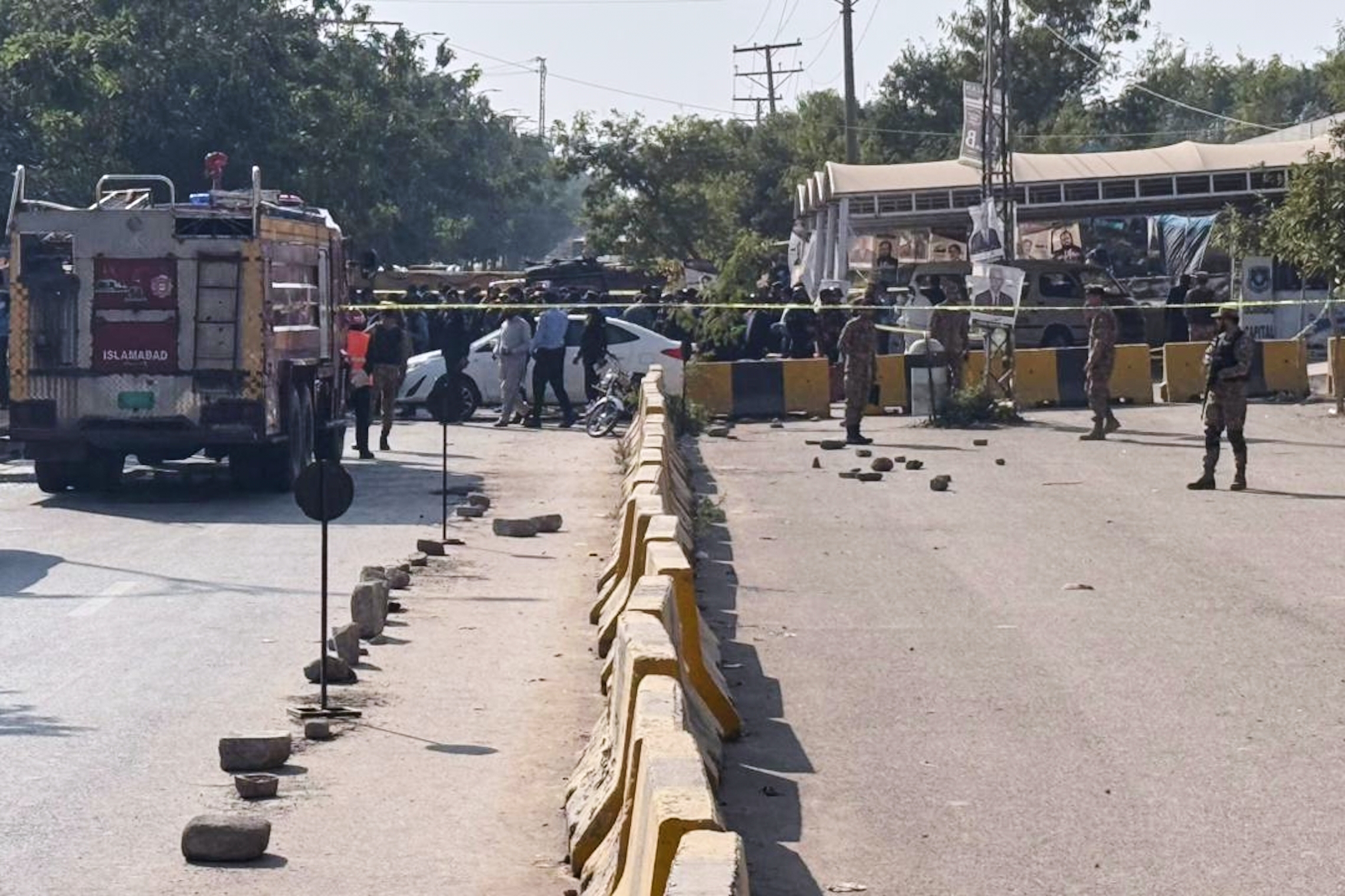 Pakistani security officials stand guard after a powerful car bomb exploded outside a district court in Islamabad, Pakistan, Tuesday, Nov. 11, 2025.